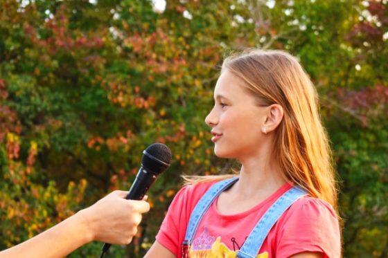 How to help your kid overcome stage fright- A girl getting interviewed