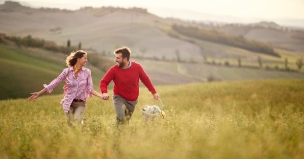 How to maintain self-care in a relationship-A couple running in a field