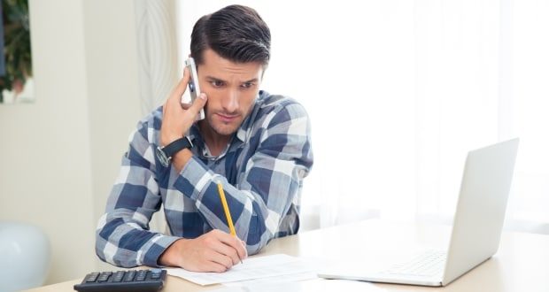 How to deal with debt collection calls- A man on the phone with a debt collector