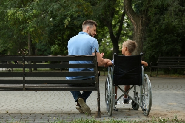 Disability pride-stepdad sitting with stepson