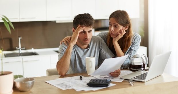 How to protect your family from inflation- A couple working out their expenses