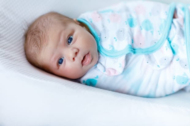 benefits of swaddling your newborn- a newborn