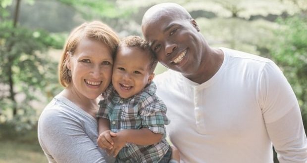 Helping your child find their voice-Interracial couple holding their son