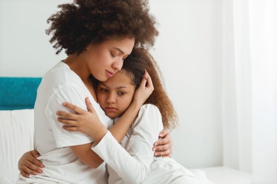 Helping your child find their voice- A mom hugging her daughter
