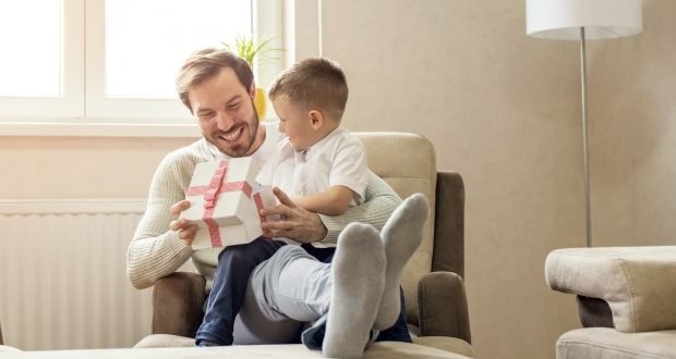 Guide for buying gifts for stepchildren- A stepdad presenting a gift to son