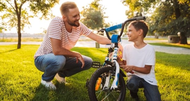 Teaching your children problem solving skills- Dad teaching son how to fix a bike