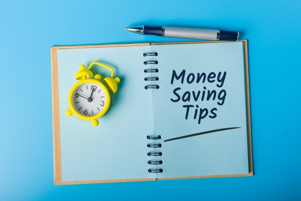 Money saving tips- An alarm clock on a book