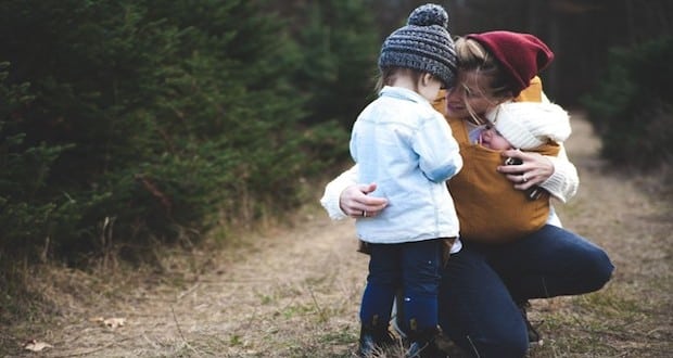The importance of acceptance - A parent giving her kids warm hugs