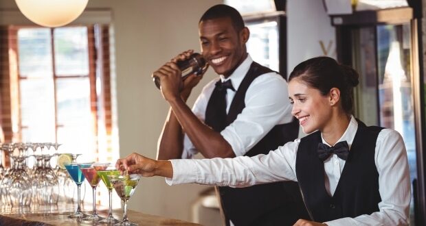 Bartender- Male and female bartenders serving drinks