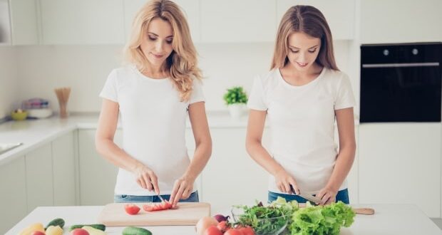 How to help your teen transition to a vegan lifestyle - mom and teen girl prepping veggies