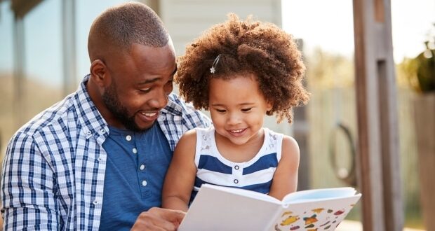 Reading out loud to your children- stepdad reading with his stepdaughter