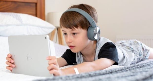 Impact Of Screens On Kids' Cognitive Health- A child using a tablet