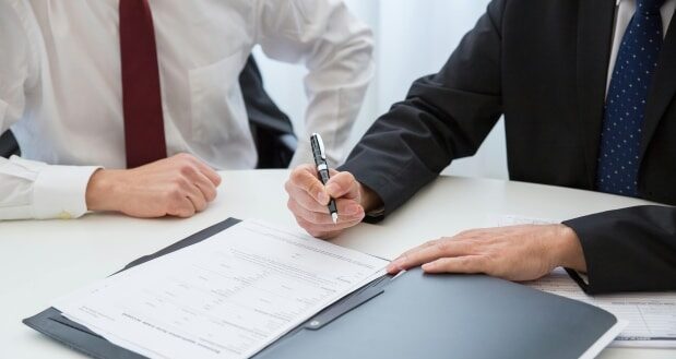 Why you need an experienced criminal lawyer - Criminal lawyer signing documents