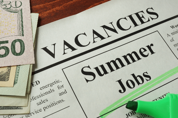 Newspaper with ads summer jobs vacancy.