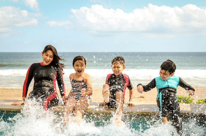 National Learn to Swim Day - Mom and kids splashing water