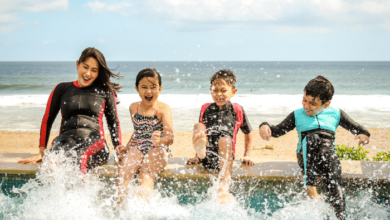 National Learn to Swim Day - Mom and kids splashing water