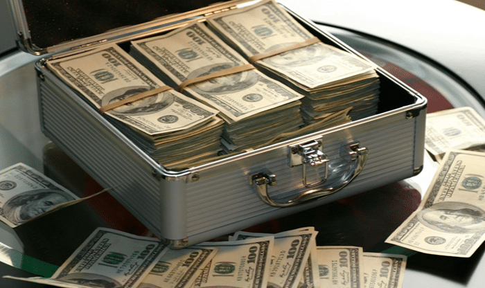 Transitioning To An Asset-Backed Currency - briefcase full of $100 bills and bills on the table