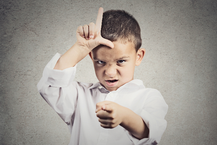 How permissive parenting leads to rude kids-Angry boy displaying loser sign