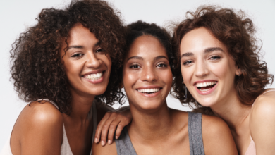 Women's Equality Day- Three women smiling into the camera.