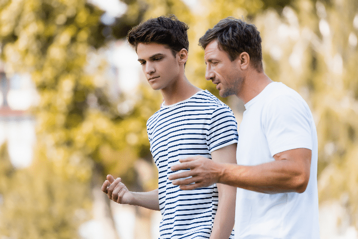 supporting teen stepchildren-stepdad speaking with teenager