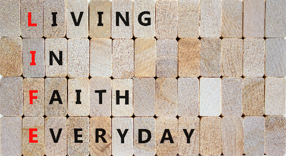 Concept words LIFE living in faith everyday on wooden blocks on beautiful wooden background