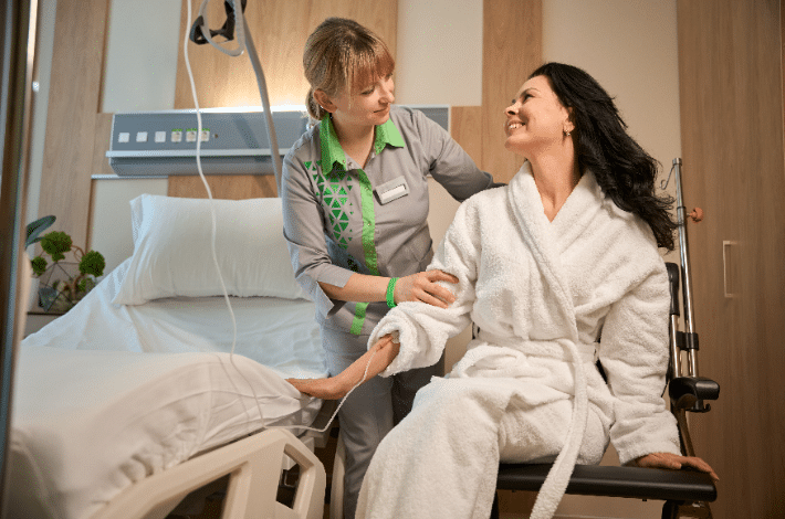 Patient transfer aids- a carer helping a patient into bed