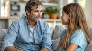 communication strategies for parents-A stepdad and his daughter are sitting and talking on a sofa.