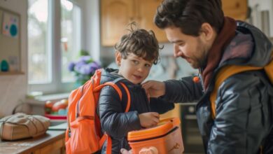 Stepdad morning routine tips-A stepdad helps his son get ready for kindergarten by adjusting his backpack and lunchbox