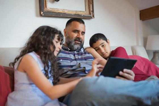 Stepdad with tablet educating kids