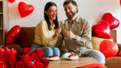 Valentine’s Day for blended families-Happy couple celebrating Valentine's Day, having romantic dinner, clinking champagne glasses and eating desserts