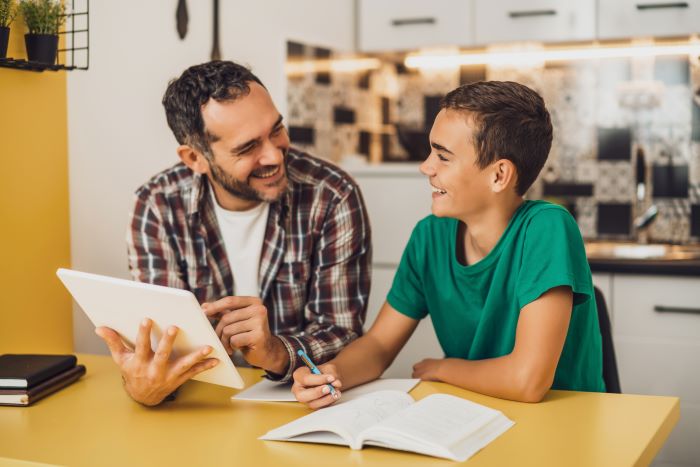 Homework help for stepkids-Stepdad helping his stepson with homework.