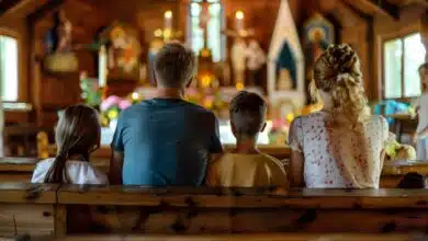 Spiritual leadership for stepdads- A family of four sits together in a church pew, facing the altar and participating in a worship service, symbolizing faith, unity, and community.