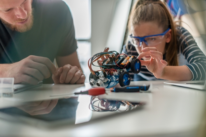 Building Confidence and Life Skills in Your Stepchildren-Stepdad and stepdaughter working on school project