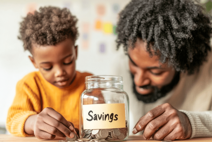 Teaching children about money-Family Financial Literacy Glass Jar of Savings with Stepfather and stepson