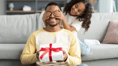How To Choose The Perfect Father's Day Gift - daughter giving dad a surprise gift