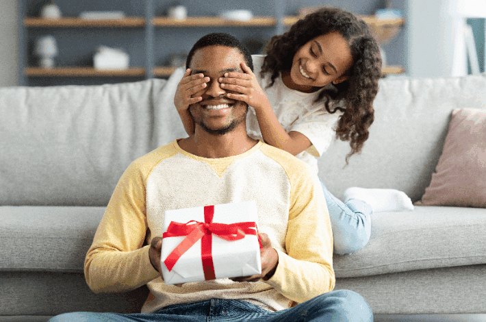 How To Choose The Perfect Father's Day Gift - daughter giving dad a surprise gift