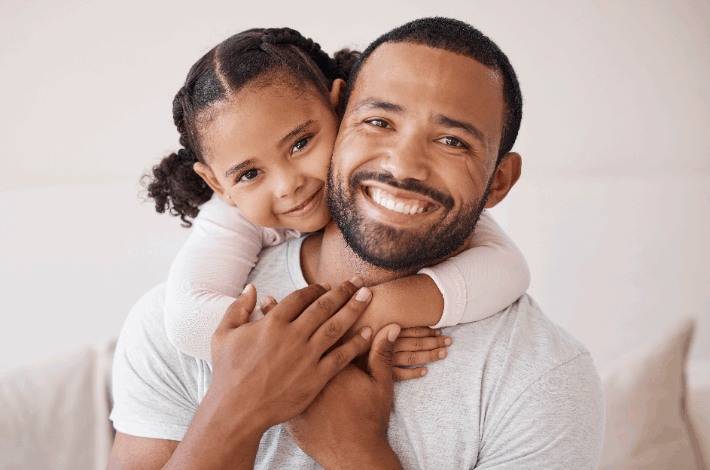 How Stepdads Positively Impact Mental Health - stepdaughter with her arms around her stepdads neck