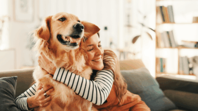National Dog Day- dog owner happily hugging her pet