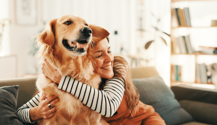 National Dog Day- dog owner happily hugging her pet
