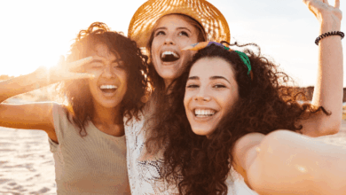 National Friendship Day - three friends smiling into the camera