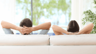 How to rest recharge and laugh - a couple facing away from the camera with both hands resting behind their heads in a relaxed posture