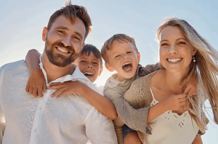 National Stepfamily Day- A happy stepfamily smiling into the camera