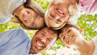 What Do You Teach Your Children By The Way You Treat Their Mother? A happy family smiling into the camera