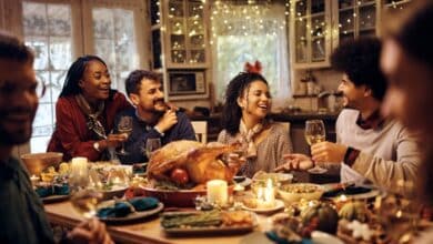 Thanksgiving message for stepdads-Multiracial group of friends have fun while talking during Thanksgiving dinner at dining table