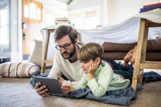 Stepdad bonding with stepson under a tent