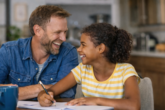 Stepdad helping stepdaughter with homework