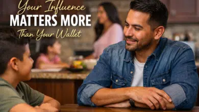 A stepfather sitting at a kitchen table with family in the background. The children are interacting with him while the headline text overlay reads