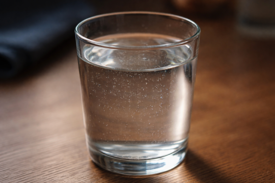 The Hidden Invasion - Glass of water containing invisible microplastics particles