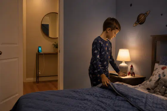 Back to school healthy checklist - Child-preparing-for-bed-while-a-phone-charges-outside-the-bedroom