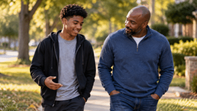 Stepdad building trust with his teenage stepson during a relaxed walk and conversation.